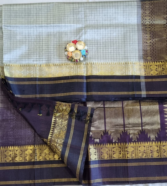 Silver colour Kuppadam pattu saree with all over checks and zari woven brown border and rich pallu