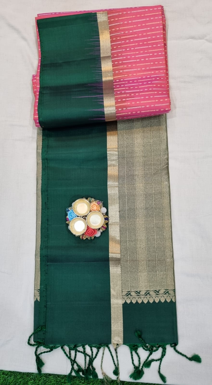 Soft silk pink colour saree with silver and golden zari weaves with simple bottle green border and rich pallu