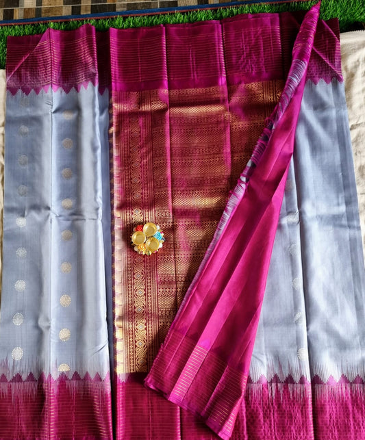 Soft silk grey colour saree with zari buta and zari lines woven purple border with rich pallu