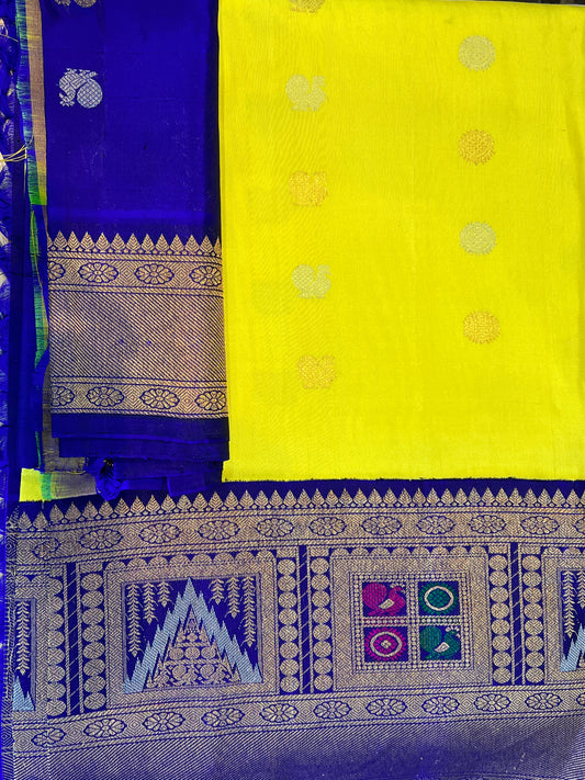 Yellow colour pure Gadwal Pattu saree with bluish purple heavy border